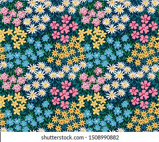 Vintage floral background. Seamless vector pattern for design and fashion prints. Flowers pattern with small colorful flowers on a dark blue background. Ditsy style.