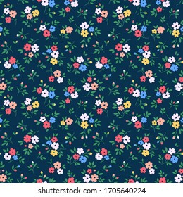 Vintage floral background. Seamless vector pattern for design and fashion prints. Flowers pattern with small colorful flowers on a navy blue background. Ditsy style.