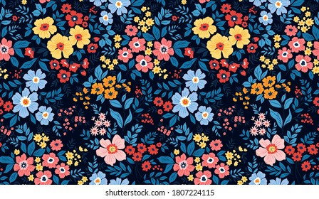 Vintage floral background. Seamless vector pattern for design and fashion prints. Flowers pattern with small colorful flowers on a dark blue background. Ditsy style.