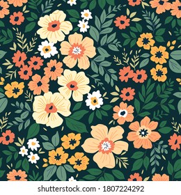 Vintage floral background. Seamless vector pattern for design and fashion prints. Flowers pattern with small yellow-orange flowers on a dark green background. Ditsy style.