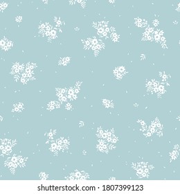 Vintage floral background. Seamless vector pattern for design and fashion prints. Flowers pattern with small white flowers on a light blue background. Ditsy style.