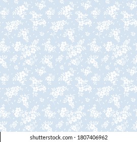 Vintage floral background. Seamless vector pattern for design and fashion prints. Flowers pattern with small white flowers on a light blue background. Ditsy style.