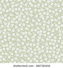 Vintage floral background. Seamless vector pattern for design and fashion prints. Flowers pattern with small white flowers on a ivory background. Ditsy style. Stock vector.