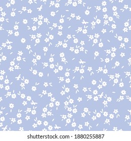 Fondo floral vintage. Patrón vectorial transparente para el diseño y las impresiones de moda. Flores con flores blancas pequeñas sobre un fondo azul claro. Estilo marrón.