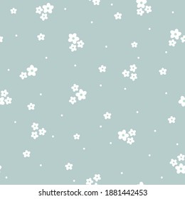 Vintage floral background. Seamless vector pattern for design and fashion prints. Floral pattern with small white flowers on a pale blue background.