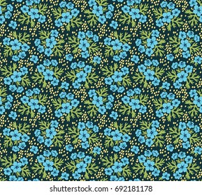 Vintage floral background. Seamless vector pattern for design and fashion prints. Flowers pattern with small blue flowers on a dark blue background. Ditsy style. 