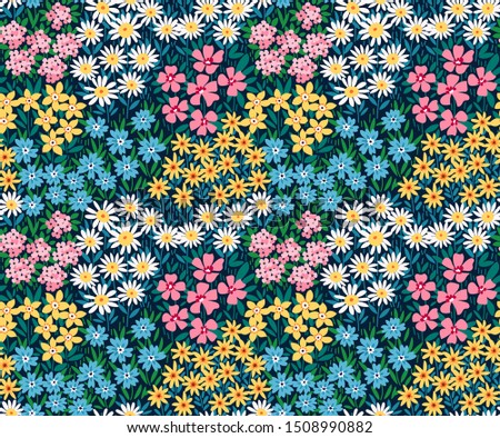 Vintage floral background. Seamless vector pattern for design and fashion prints. Flowers pattern with small colorful flowers on a dark blue background. Ditsy style.