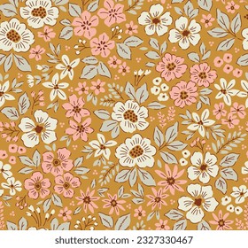 Vintage floral pattern in small abstract flowers. Small rose pink and white flowers. Gold background. Ditsy print. Floral seamless background. Liberty template for fashion prints. Stock pattern.