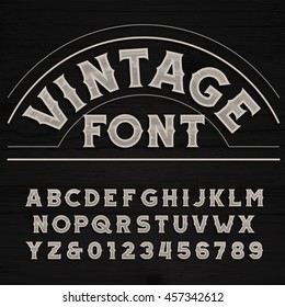 Vintage font. Retro alphabet. Dirty letters on a grunge wooden background. Vector typeface.