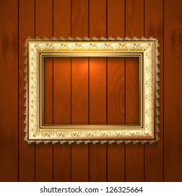 Vintage gold frame on a wooden texture