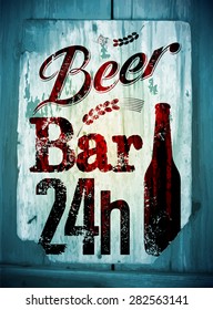 Vintage grunge style beer bar poster. Retro typographical vector illustration on wood background. Eps 10.