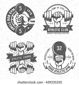 Vintage gym and fitness club emblems with letterpress or rubber stamp effect.  Isolated vector illustration. Background on separate layer.