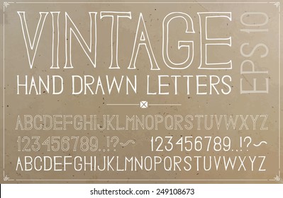 Vintage hand drawn alphabet on plywood background