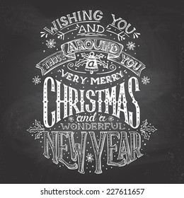 Vintage hand-lettering Christmas and New Year wishes with chalk on blackboard background, greeting card