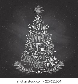 Vintage hand-lettering Christmas tree greeting card with chalk on blackboard background