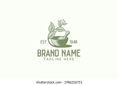 Vintage herbal logo vector graphic with mortar, pestle, and herbal.