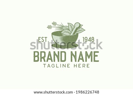 Vintage herbal logo vector graphic with mortar, pestle, and herbal.