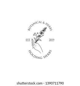 Vintage herbs logo in black and white. Herbs held by hand logo template. Botanical in hand logo template