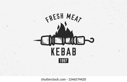 Vintage kebab logo template. Kebab or shashlik on skewer with fire flame isolated on white background. Vector illustration