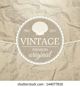 Vintage label with seashell on crumpled paper background