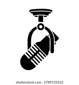 Vintage microphone suspended from a ceiling mount bracket for audio recording or broadcasting