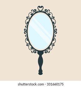 vintage mirror with a handle on a background