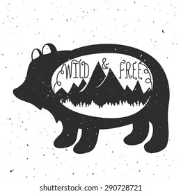 Vintage monochrome vector hand drawn illustration. Wild & free. Typography poster with rustic background, bear silhouette, mountains and forest. T-shirt design, home decoration, greeting postal cards