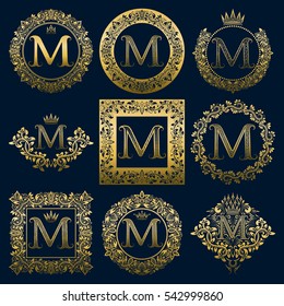 Vintage monograms set of M letter. Golden heraldic logos in wreaths, round and square frames.