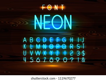 Vintage neon font and alphabet on wooden background.