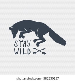 vintage old logo or badge, label engraved and old hand drawn style with wild wolf or red fox . stay wild.