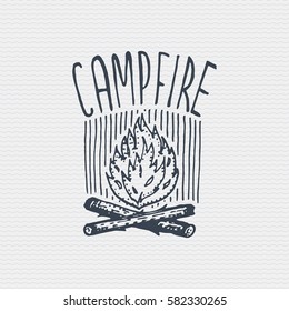 vintage old logo or badge, label engraved and old hand drawn style with campfire.