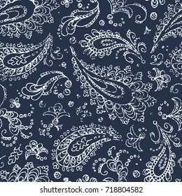 Vintage paisley ornament - seamless pattern. Grunge texture. White flowers, leaves and curls on a blue background. Handmade. Prints for textiles. Bohemian motives. Vector illustration.