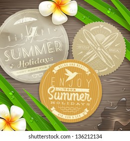 Vintage paper labels with vacation and travel emblems and tropical flowers on a wooden surface - vector illustration. (elements outside of the art-board is not cut off - they with clipping mask)