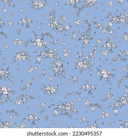 Vintage pattern of small white wildflowers on a blue background.