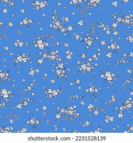 Vintage pattern of small white wildflowers on a blue background.