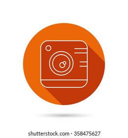 Vintage photo camera icon. Photography sign. Professional studio equipment symbol. Round orange web button with shadow.