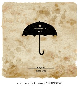 Vintage postcard. Retro umbrella on grunge background