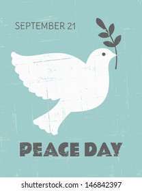 Vintage poster for the International Day of Peace with a dove carrying an olive branch.