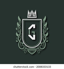 Vintage premium monogram of letter G. Heraldic coat of arms in form of shield surrounded by floral ornament and crown.