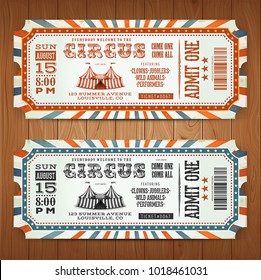 Vintage Retro Circus Tickets/
Illustration of two circus tickets, with big top, admit one coupon mention, bar code and text elements for arts festival events, on wood tiles background