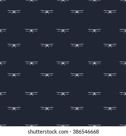 Vintage seamless background. Can be used for wallpaper, pattern fills, web page background,surface textures. Seamless pattern with white flying aircraft front view of a dark blue background