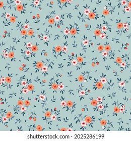 Vintage seamless floral pattern. Liberty style background of small orange coral flowers. Small blooming flowers scattered over a blue background. Stock vector for printing on surfaces and web design.