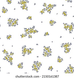 Vintage seamless floral pattern. Liberty style background of small yellow flowers. Small flowers scattered over a white background. Stock vector for printing on surfaces. Abstract flowers.