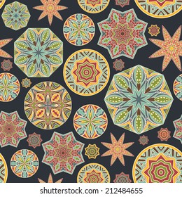 Vintage seamless pattern. Geometric pattern with abstract ethnic rounds and stars. Symmetric mandalas for tribal ornament. Retro colors background. Vector file is EPS8, all elements are grouped.