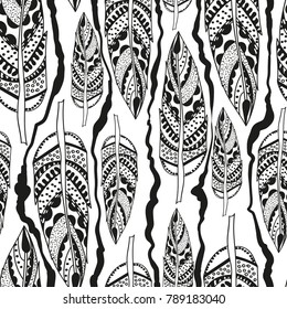 Vintage seamless pattern with tribal elements. Vector illustration with feathers and scribbled lines. Ethnic hand drawn texture, decorative background, boho style.