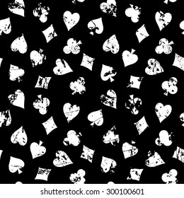Vintage, seamless, vector background with suits of playing cards. old black shabby surface with a white pattern of club, diamond, spade, heart.