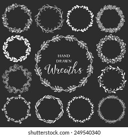 Vintage set of hand drawn rustic wreaths. Floral vector graphic on blackboard. Nature design elements.