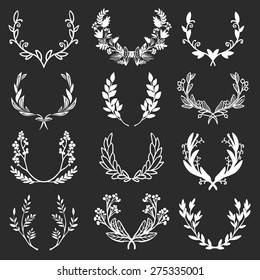 Vintage set of hand drawn rustic laurels. Floral vector graphic on blackboard. Nature design elements.