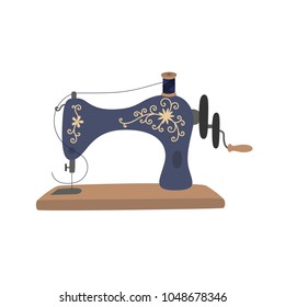 Vintage sewing machine with blue spool thread. Equipment for sew vogue clothes. Handmade