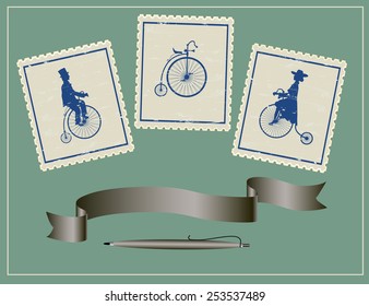 vintage stamps on a green table three vintage stamps, pen and ribbon on a green background